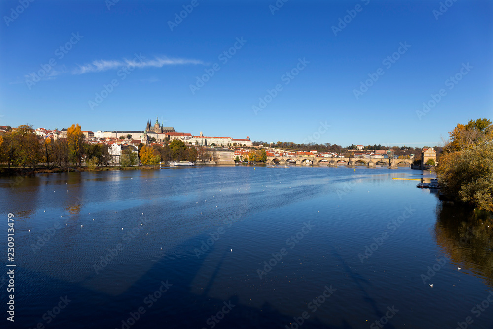 Colorful autumn Prague gothic Castle and Charles Bridge with the Lesser Town in the sunny Day, Czech Republic