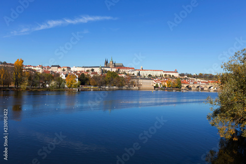 Colorful autumn Prague gothic Castle and Charles Bridge with the Lesser Town in the sunny Day  Czech Republic