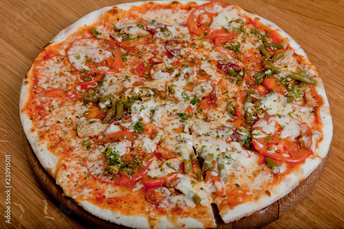 Home pizza on a wooden table.