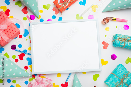Festive frame or bright background, gift, confetti, carnival hat and streamer. Flat style. Birthday or holiday card with a copy.