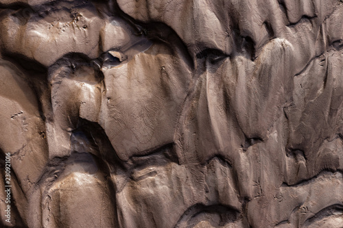 Slika na platnu Glacial riverbank shore with wet black silt sand mud