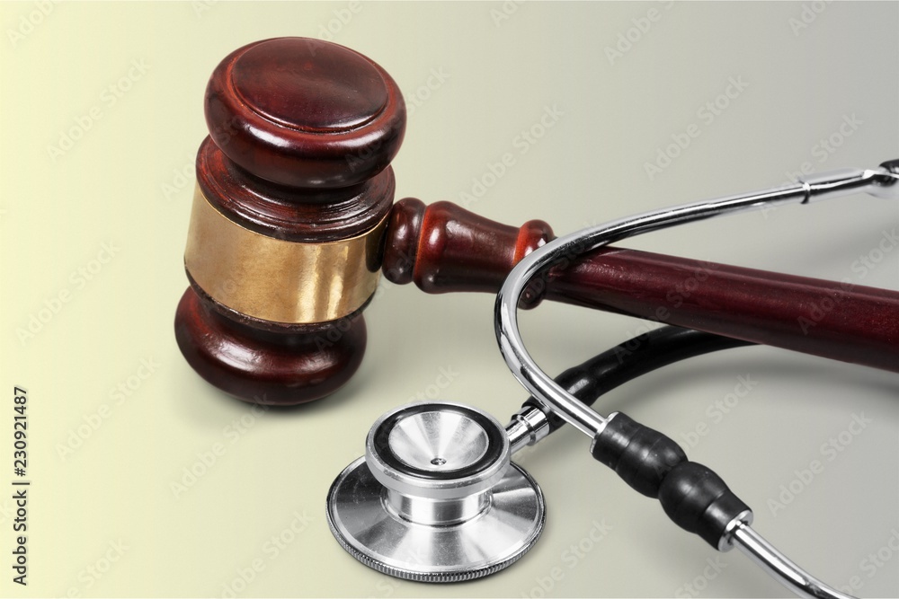 Gavel and stethoscope on background, symbol photo Gavel and stethoscope on background, symbol photo