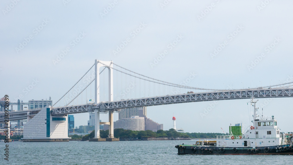 Boat on Sumida river with background on the beautiful Tokyo Rainbow Bridge.