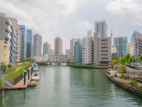 Boats on a canal in Tokyo in the middle of the city.