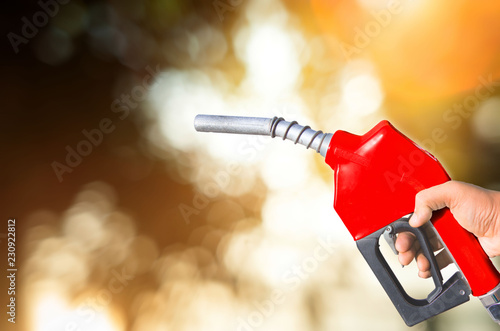 Quadro su tela Fuel nozzle Hand holding red and white scenes that are separated from the ground