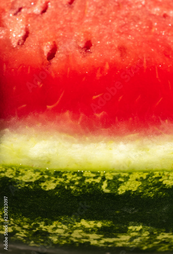background. delicious red watermelon with black seeds and green skin
