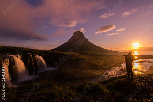 Silhouette of Photographer taking photo Kirkjufellsfoss at morning