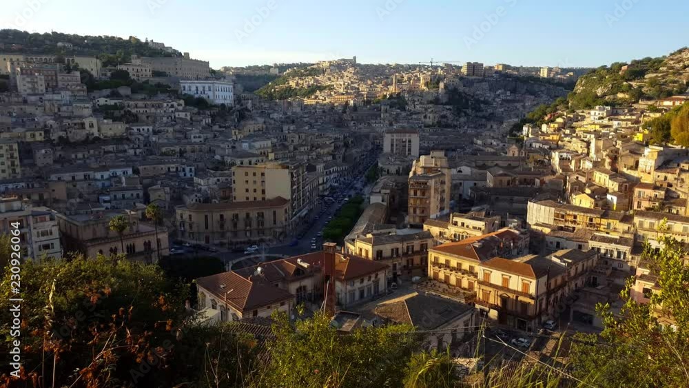 Late afternoon in the town of Modica, Sicily - Italy. Landscape images made from above the mountain. Show the main street and houses with old architecture. It shows the main street with houses. Late afternoon in the town of Modica, Sicily - Italy. Landscape images made from above the mountain. Show the main street and houses with old architecture. It shows the main street with houses.