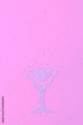A glass consisting of beads on a pink background