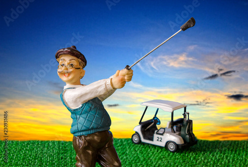 old man doll playing golf with colorful sky ,golfer,golf cart
