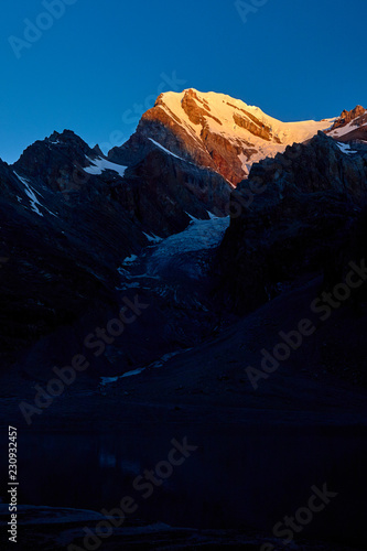 Sunset in mountains. Reflection of red sun on mountain snow peaks, Fann, Pamir Alay, Tajikistan