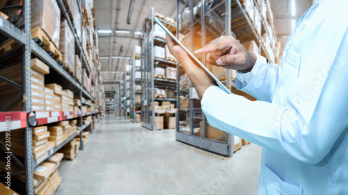 Warehouse worker or supervisor or checker check stock photo