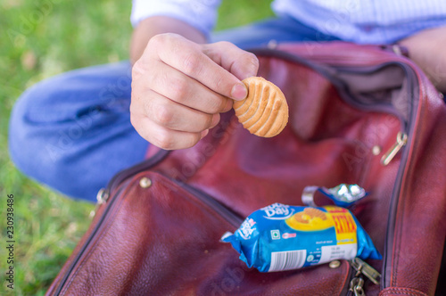 Srinagar, Jammu and Kashmir, India: Dated: June 1, 2018- A person about to eat a cookie which he just took out from the packet.
