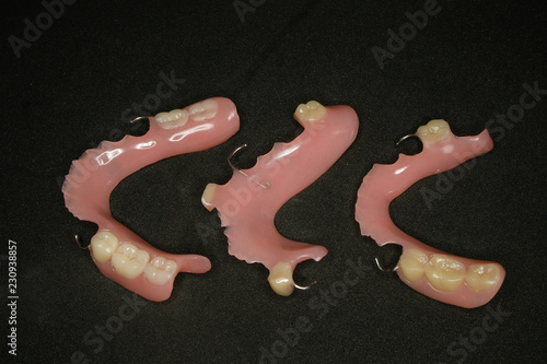 three dentures on black background