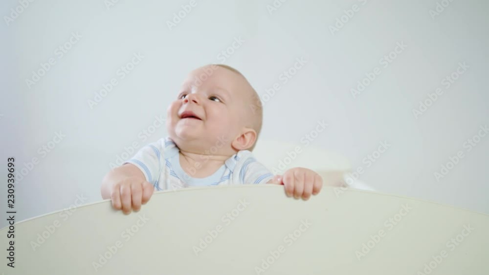 Cute baby playing in her crib at home. Close-up shot Cute baby playing in her crib at home. Close-up shot