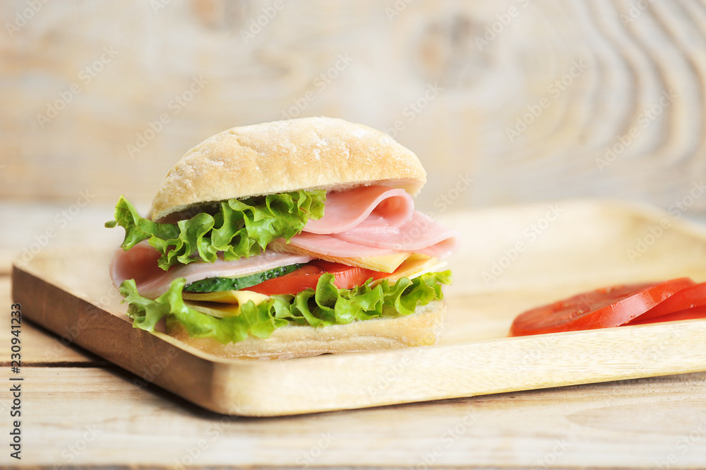 ham and cheese sandwich on wooden Board