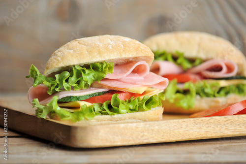 ham and cheese sandwiches on wooden Board