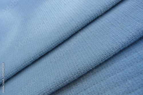 blue knitted fabric closeup background wool acrylic canvas material for clothing