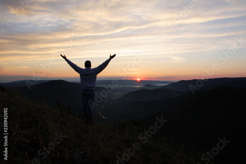 Man meets dawn on the top of the mountain. © Eugene