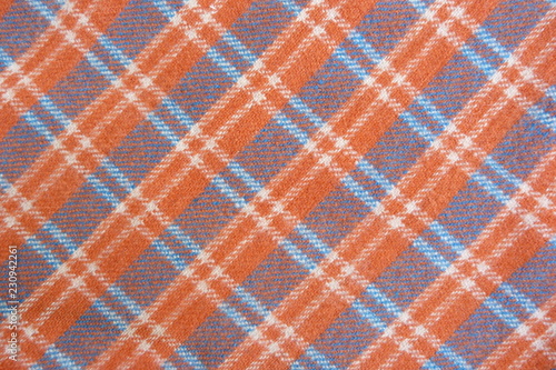 checkered wool fabric close up scottish cage drape orange white geometric pattern