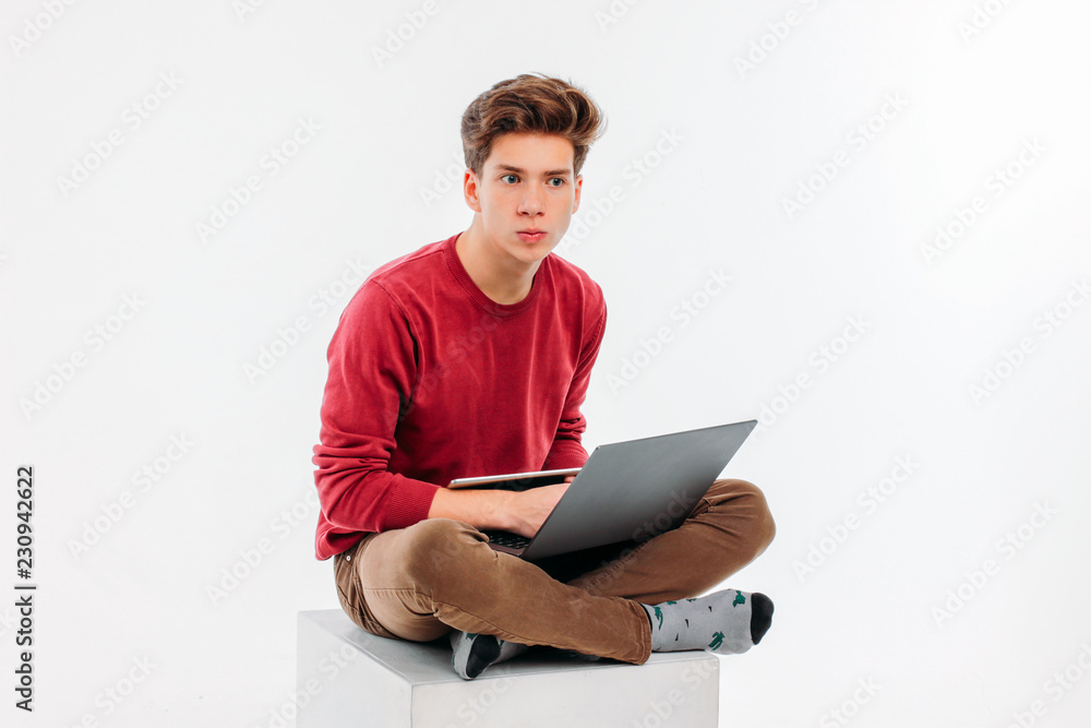 Teenager student with working at laptop and tablet on white background Teenager student with working at laptop and tablet on white background