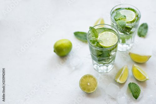 Mojito cocktail with lime,ice and mint on white background. Cuban cocktail. Copy space