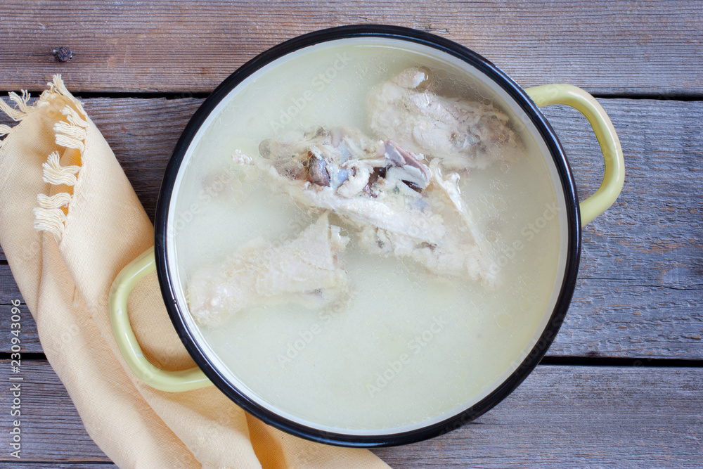 Step-by-Step Cooking Chicken Soup with Noodles and Potatoes, Step 2 - Chicken Broth, Selective Focus, Culinary Recipe Step-by-Step Cooking Chicken Soup with Noodles and Potatoes, Step 2 - Chicken Broth, Selective Focus, Culinary Recipe