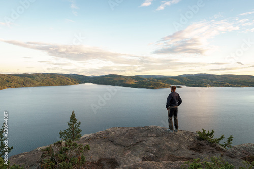 Hiker at moutain peak, sunset view