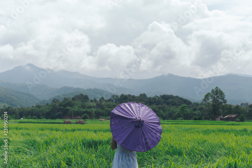 woman with umbrella in the field  travel concept.