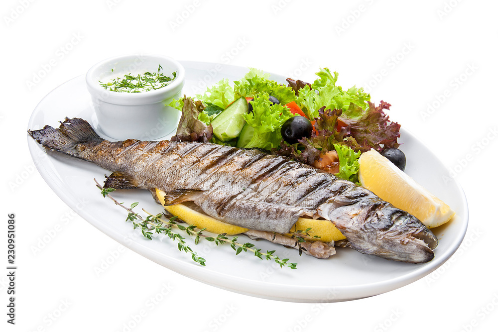 Seabass baked with herbs on a white plate