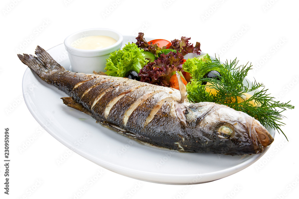 Seabass baked with herbs on a white plate Seabass baked with herbs on a white plate