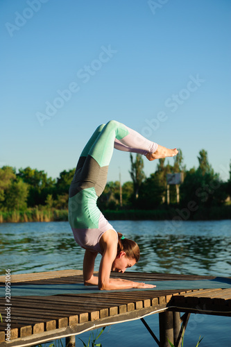 Healthy woman lifestyle balanced practicing meditate and energy yoga on the bridge in morning the nature. Healthy Concept.