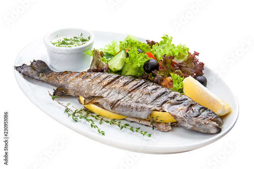 Seabass baked with herbs on a white plate