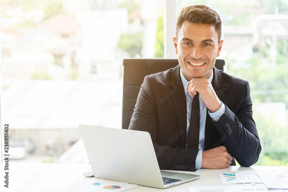Portrait of young businessman working in office with smile. Manager or smart working people concept. Portrait of young businessman working in office with smile. Manager or smart working people concept.