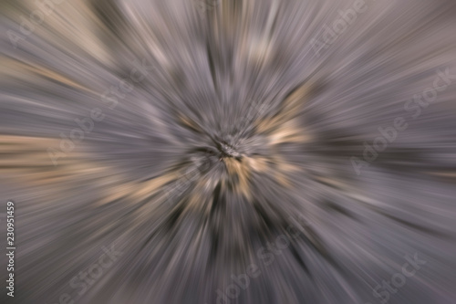 Grey abstract background in the form of blurred rays radiating from the center