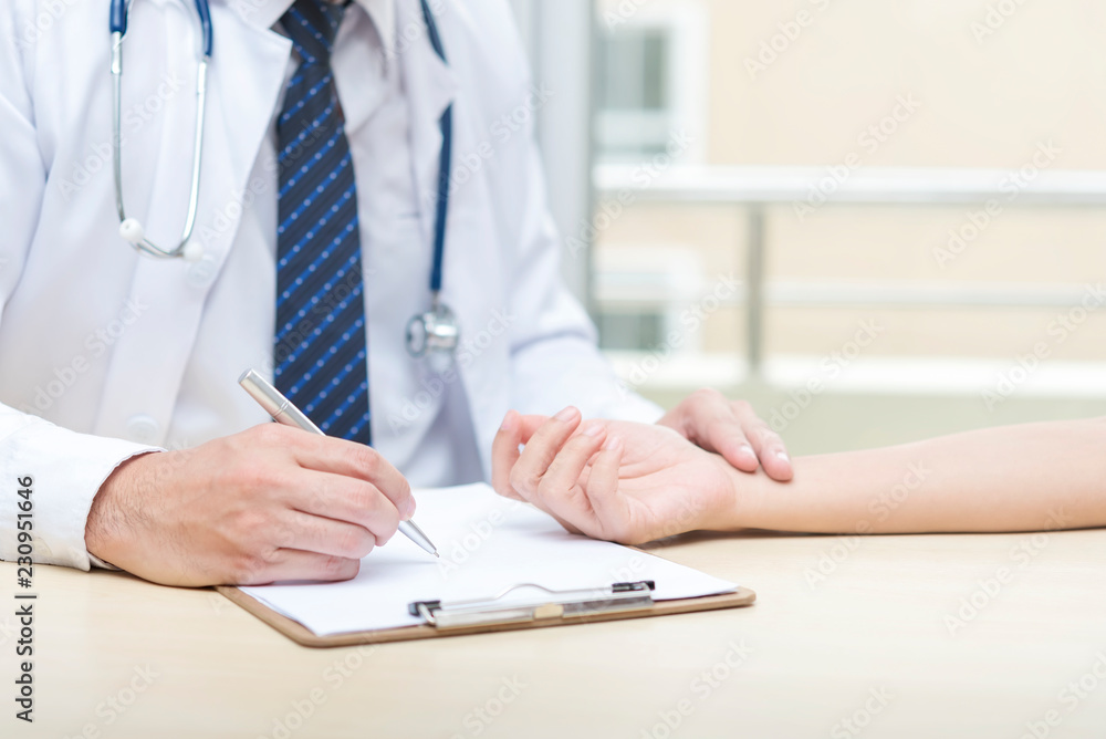Fototapeta premium Healthcare concept. Doctor checking heart pulse for patient.
