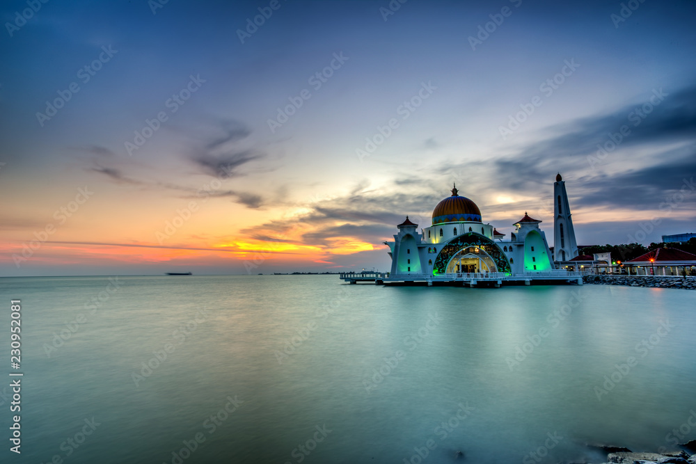 Beautiful sunset over the majestic mosque, Malacca Straits Mosque (Masjid Selat). Soft focus due to slow shutter shot.