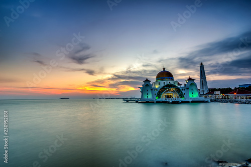 Beautiful sunset over the majestic mosque, Malacca Straits Mosque (Masjid Selat). Soft focus due to slow shutter shot. photo