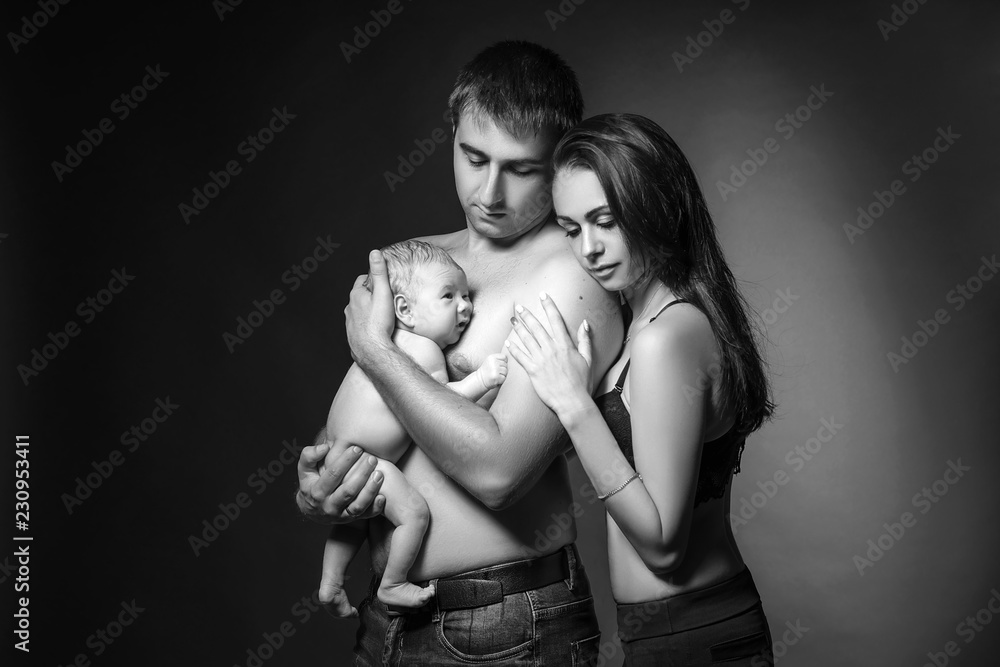 happy family dad mom and baby in Studio on background