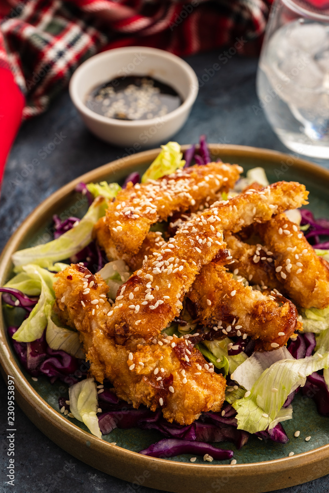 Salad with warm glazing chicken, sprinkled with sesame seeds. Chinese cuisine. Asian culture Salad with warm glazing chicken, sprinkled with sesame seeds. Chinese cuisine. Asian culture