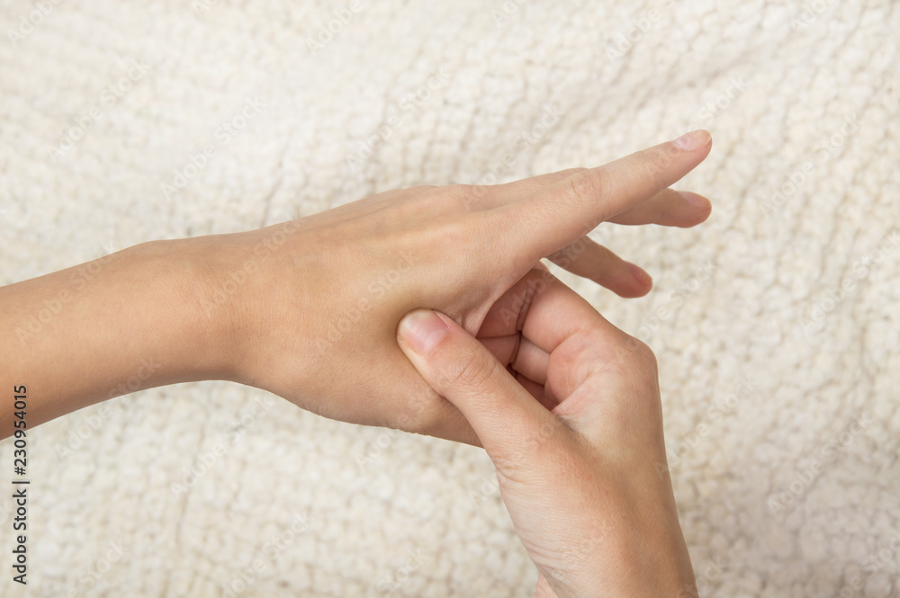 acupressure, the girl does self-massage; massaging points on the hands acupressure, the girl does self-massage; massaging points on the hands