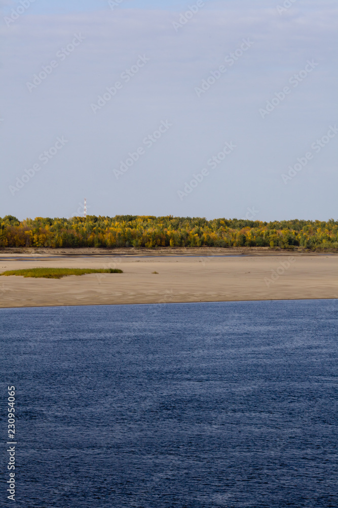 A natural blurred landscape of the river in autumn. Astrakhan Region, Russia. Defocused.River sand beach.