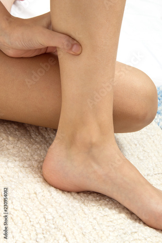 acupressure, the girl does self-massage; massaging points on the legs