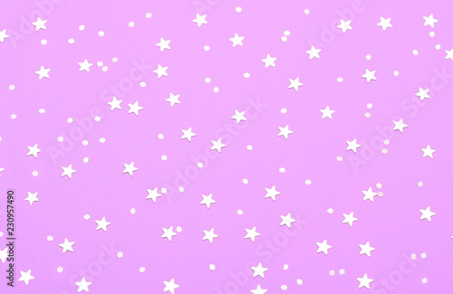 Christmas pattern made of silver stars on pink background. Winter concept. Flat lay.