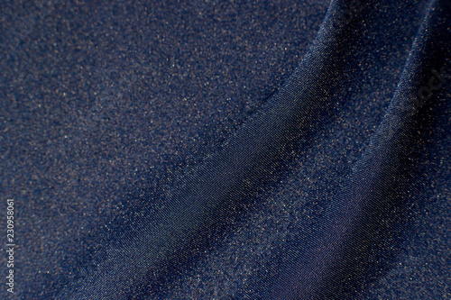 Foto The texture of the blue fabric with folds