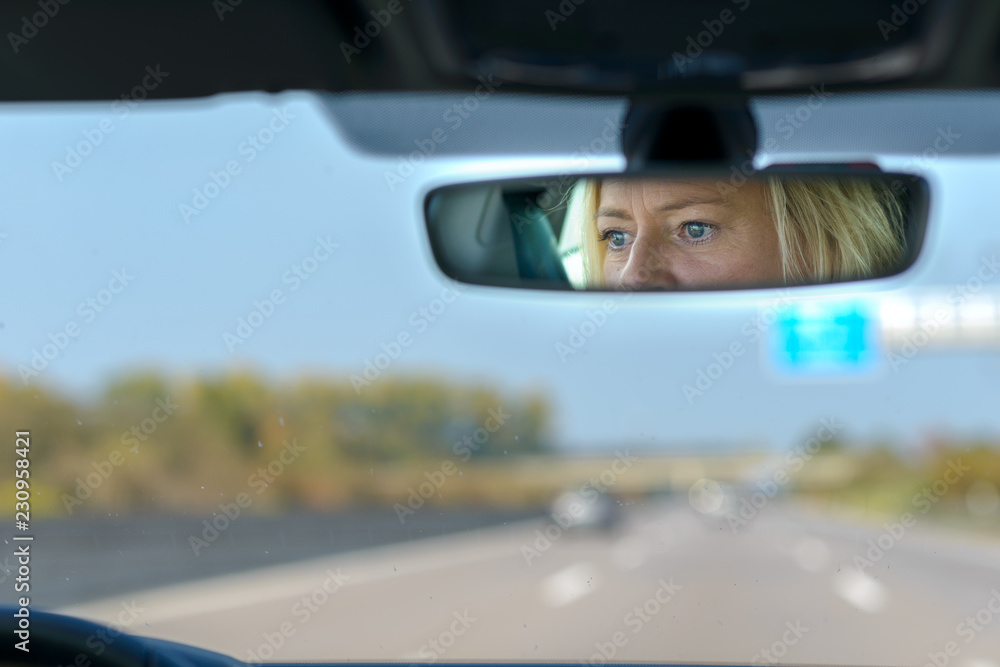 Woman driving a car on a motorway