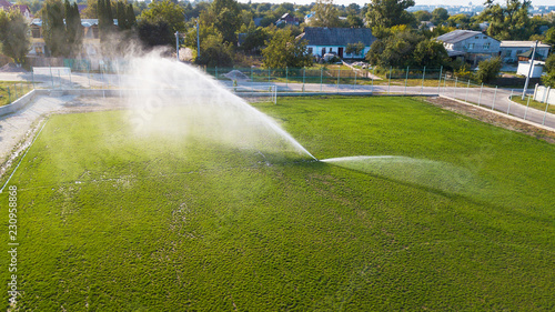 Aerial view of watering the lawn of a football field