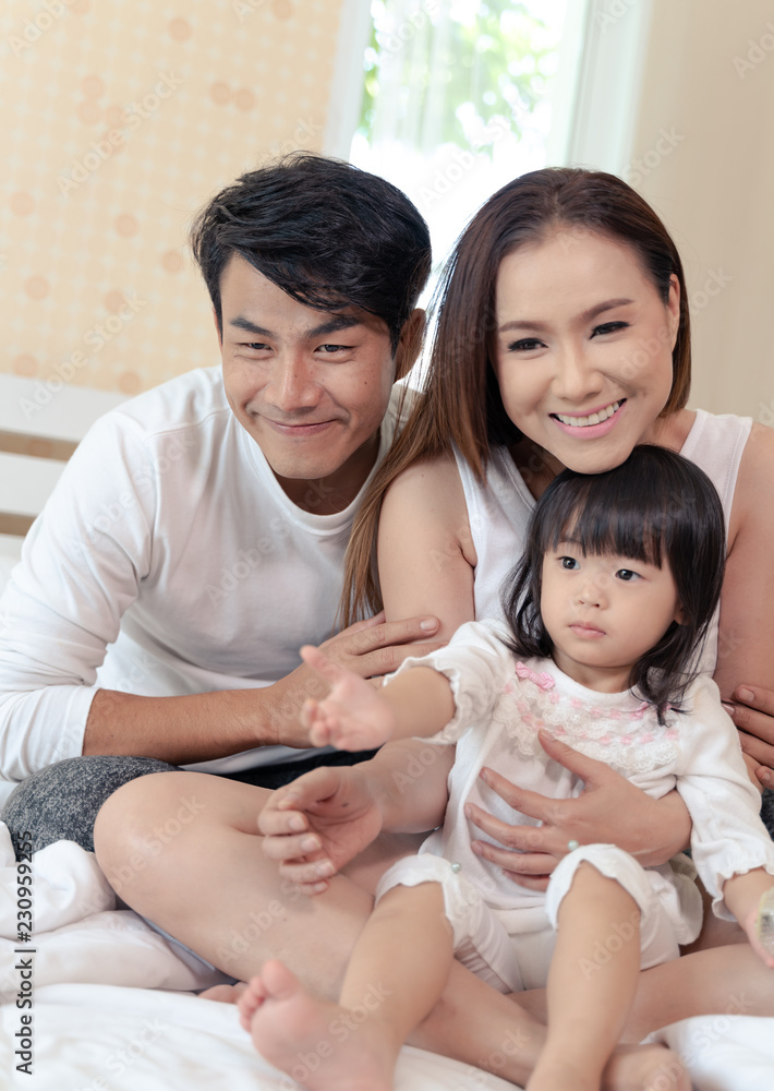 Happy family relaxing in bed. Happy family relaxing in bed.
