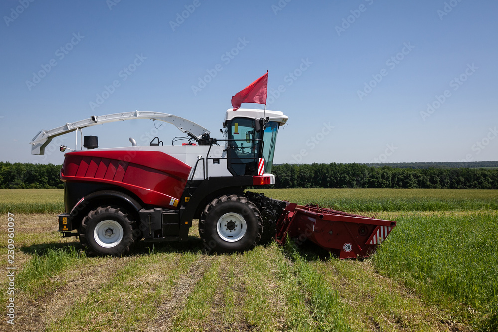 heavy powerful red harvester in the field during the demonstration heavy powerful red harvester in the field during the demonstration