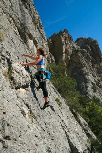 Young female climber on the rocks in the Crimea.